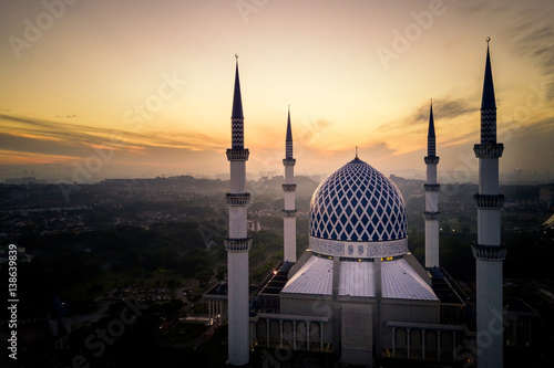 Aerial - Sunrise at a mosque. Sultan Salahuddin Abdul Aziz Shah Mosque is Malaysia's largest mosque and also the second largest mosque in Southeast Asia.
