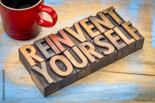 reinvent yourself - motivational words in wood type photo