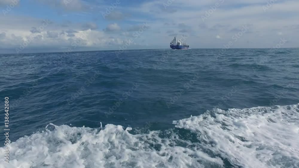 Cargo ship sailing in distance Cargo ship sailing in distance
