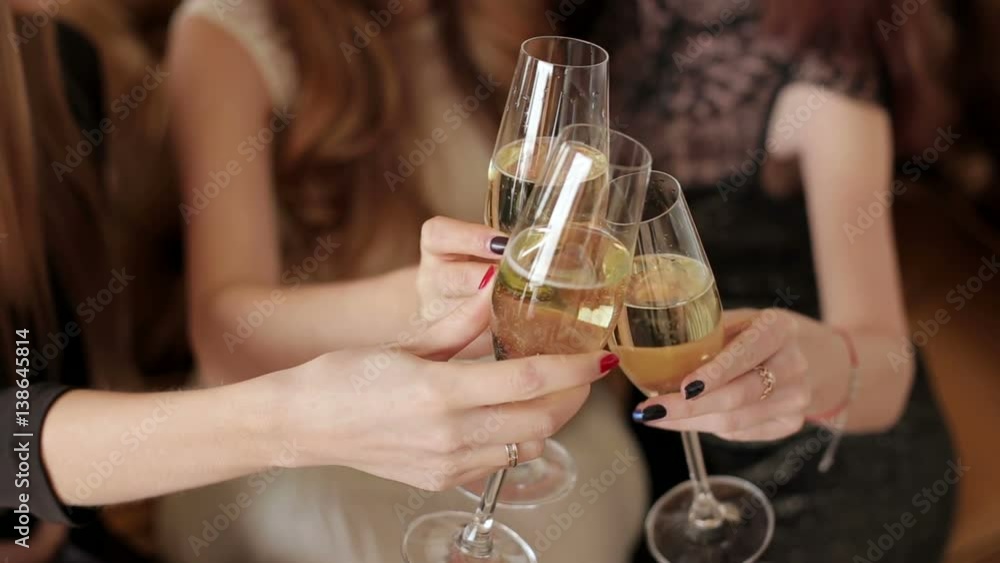 Close-up of three women clinking with glasses of shampagne. Close-up of three women clinking with glasses of shampagne.