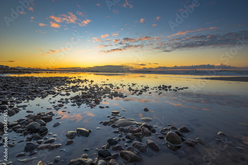 Baltic sea at beautiful sunrise,stony beach after storm © Mike Mareen