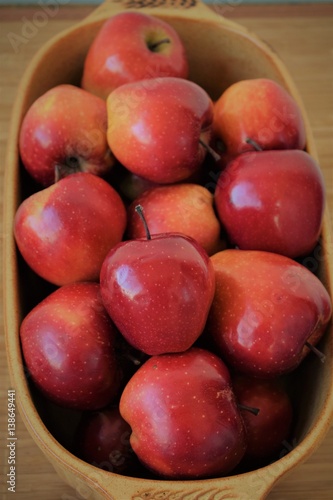 Red apples arranged in rustic bowl