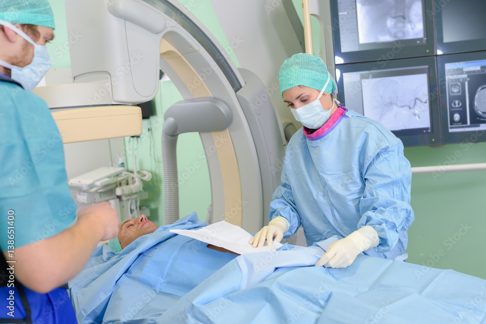 Surgeons preparing for medical procedure Surgeons preparing for medical procedure