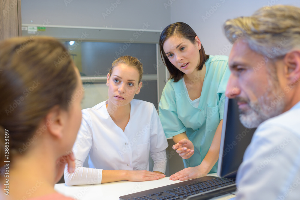 Fototapeta premium Medical staff talking to couple