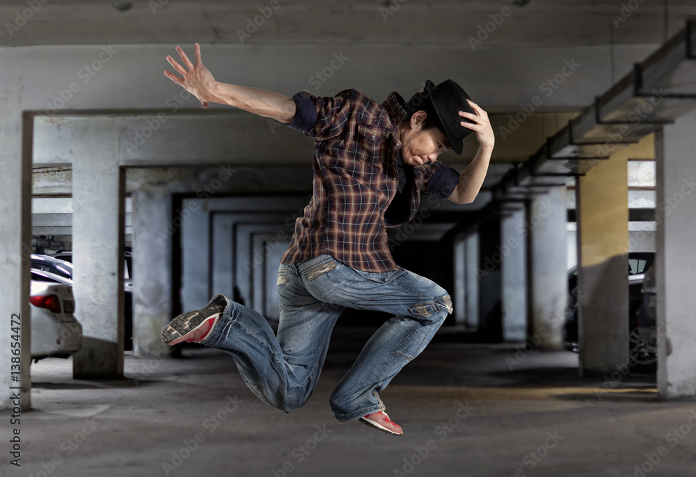 Naklejka premium Man break dancing on wall background