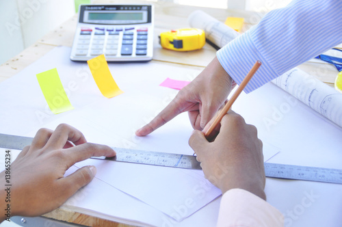 Wallpaper Mural A young Asian consultant  Architect drawing on architectural project business, architecture, building, construction and people concept - close up of architect hands with blueprint Torontodigital.ca