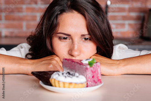 Woman on the diet craving to eat cake