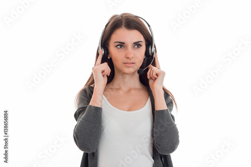 young girl in headphones seriously looks toward