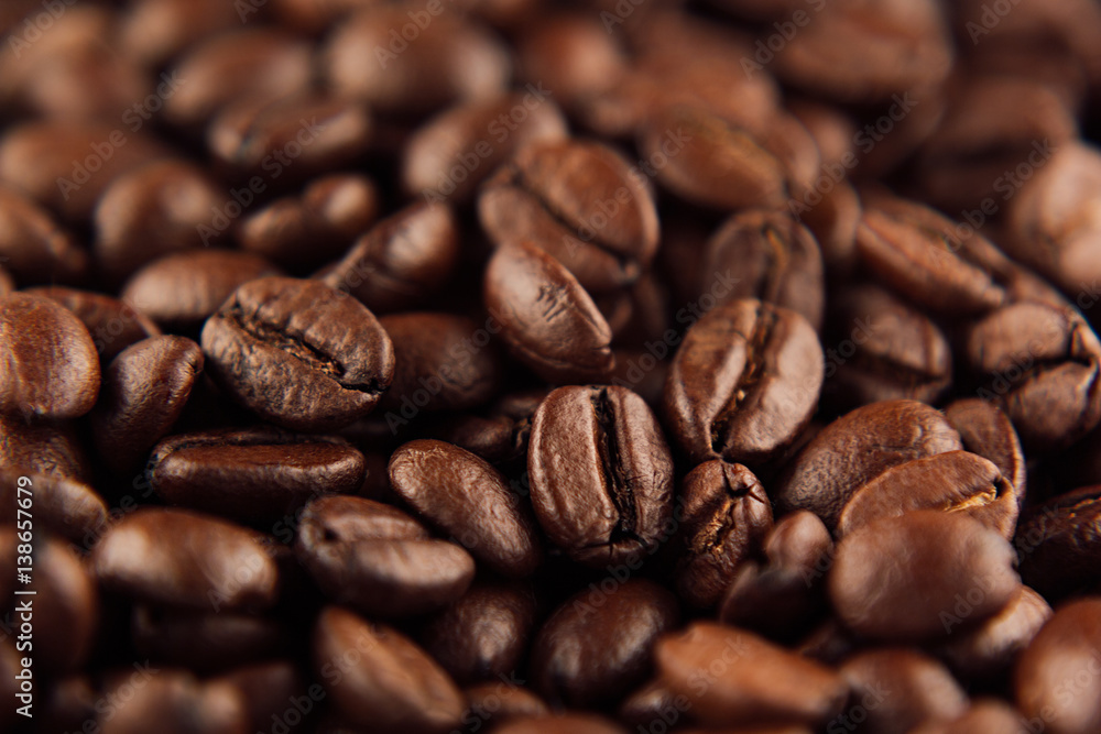 Roasted coffee beans closeup top view as background. Roasted coffee beans closeup top view as background.