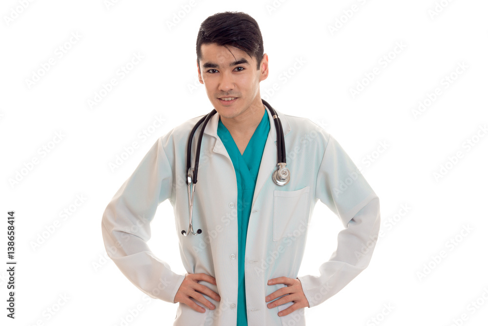 beautiful young man doctor in uniform with stethoscop on his neck looking and smiling on camera isolated on white background beautiful young man doctor in uniform with stethoscop on his neck looking and smiling on camera isolated on white background