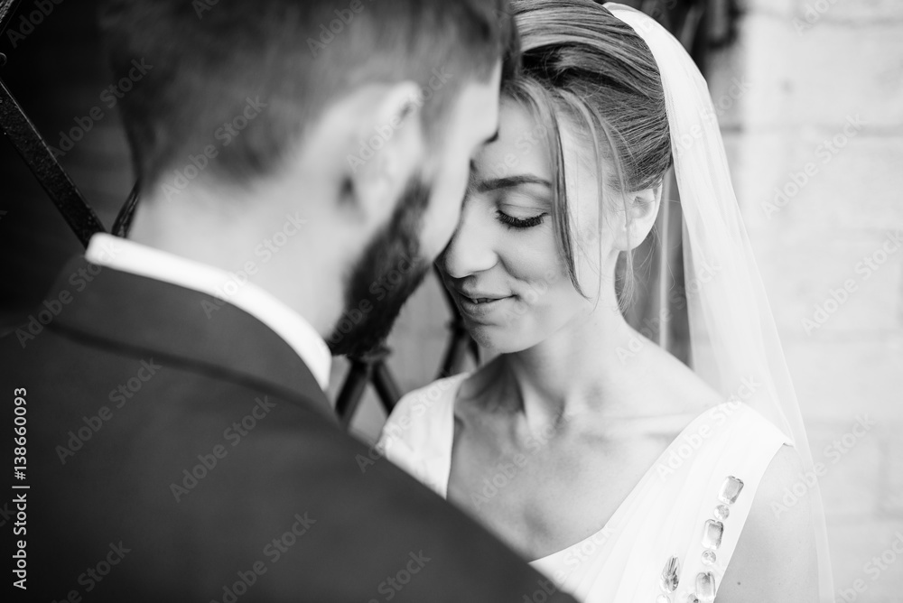 Close up portrait of wedding couple near old wrought iron gates. Black and white photo. Close up portrait of wedding couple near old wrought iron gates. Black and white photo.