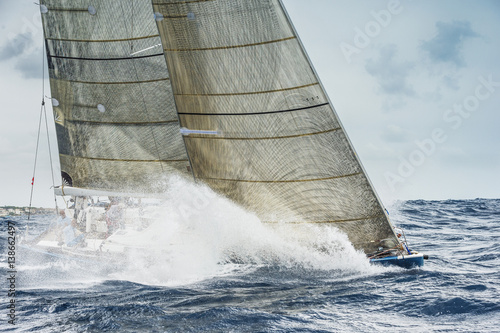 Sailing boat breaking waves