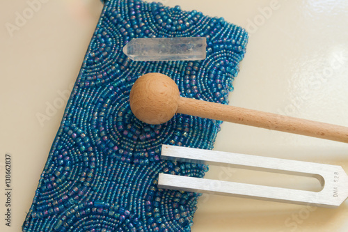 tuning fork and crystal on table .
