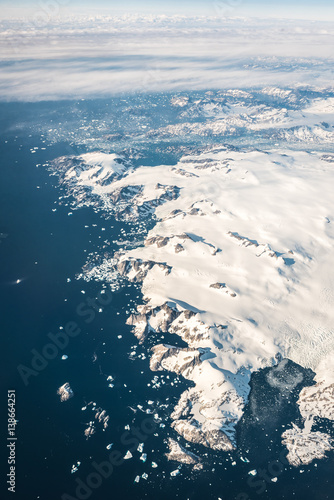 Greenland Mountain coastline under the plane wings
