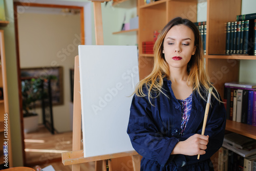 young woman artist begins to draw a new paint