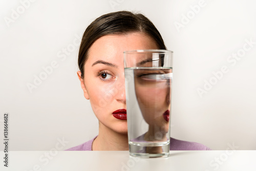 Woman Face Distortion In Glass Of Water