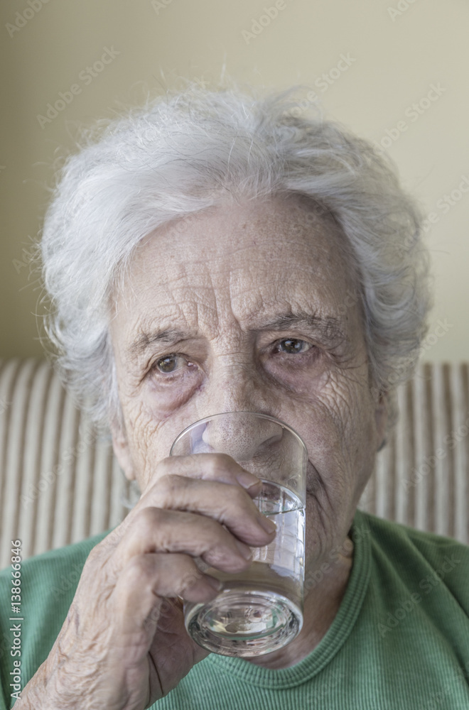 senior woman drinking water senior woman drinking water