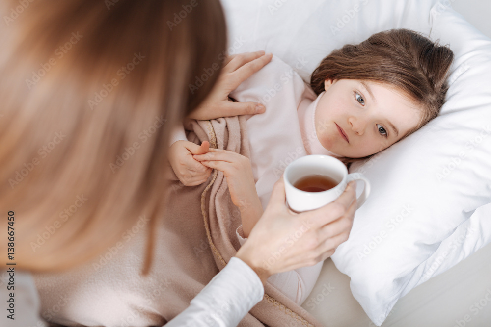 Loving mother taking care of her little sick daughter Loving mother taking care of her little sick daughter
