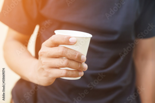 Man holding a paper coffee cup.Coffee lifestyle comcept.