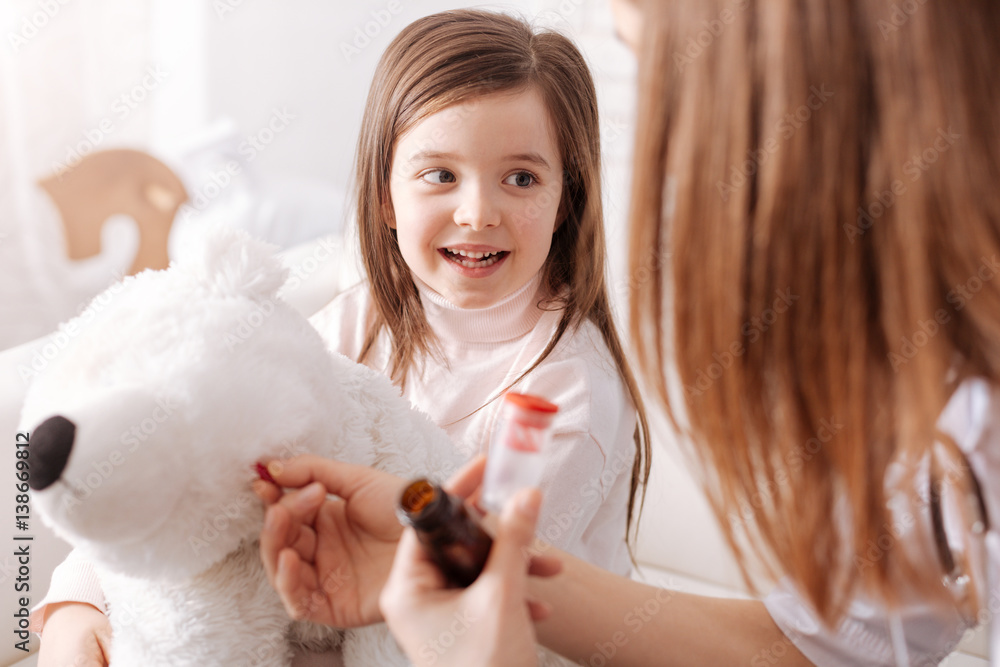 Professional doctor giving pills to little girls toy Professional doctor giving pills to little girls toy
