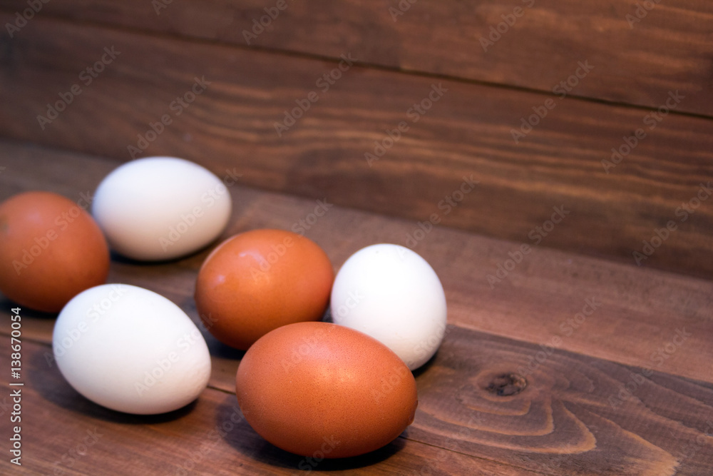 fresh brown and white eggs on a wooden background fresh brown and white eggs on a wooden background