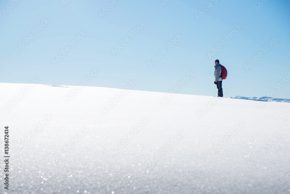 man enjoying the beautiful view of winter mountains
