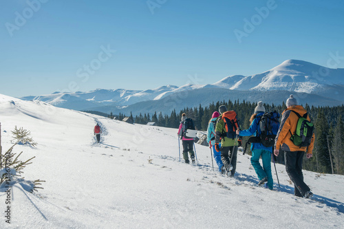 group travel of tourists with backpacks in the mountains, teamwork, sports, lifestyle concept