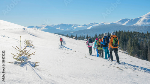 group travel of tourists with backpacks in the mountains, teamwork, sports, lifestyle concept