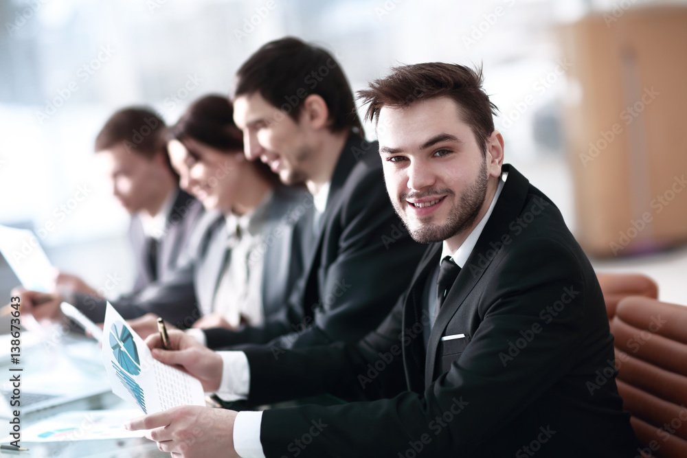 Smiling business people with paper work in board room Smiling business people with paper work in board room