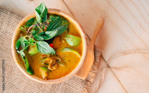Vintage style Thai traditional food style spicy muslim curry (Massaman chicken curry) on wooden background wallpaper focus one point shallow with depth of field