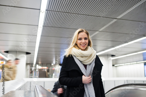 Young woman standing at the escalator in Vienna subway