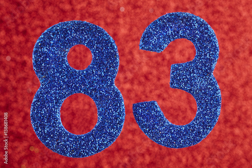 Number eighty-three blue color over a red background. Anniversary. photo