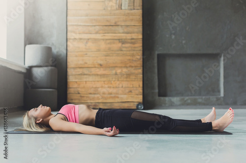 Принти на полотні Young woman in yoga class, relax meditation corpse pose