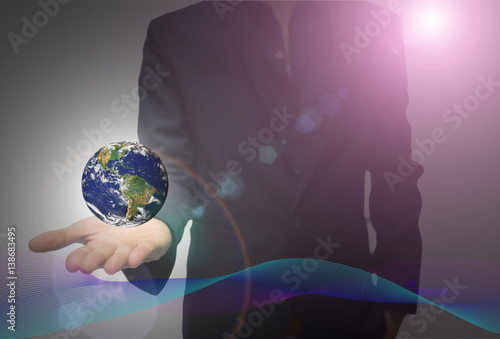 Business Man Holding Earth globe with digital Data. Elements of this image furnished by NASA