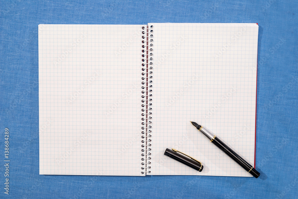 pen lies on empty pages of a notebook. pen lies on empty pages of a notebook.
