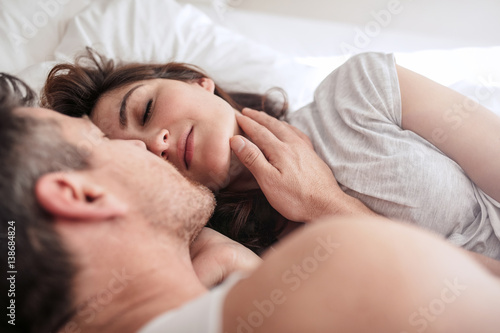 Romantic young couple on bed