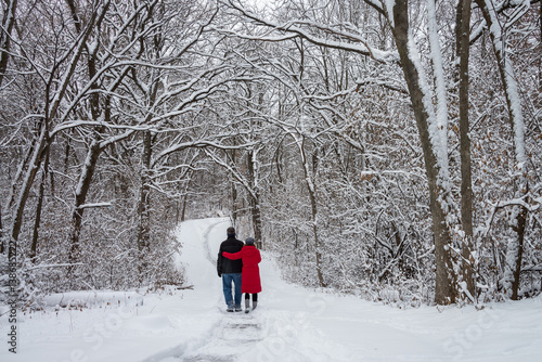couple walking through winter wonderland. Snow Covered trees 