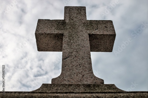 Genova (Genoa), Italy - February 22, 2017: A stone cross on a background of gray sky