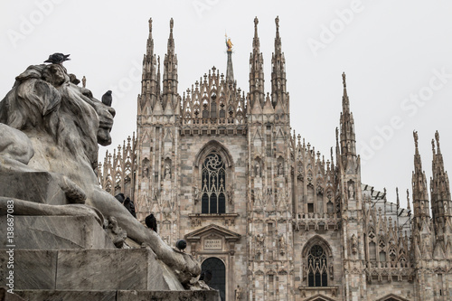 Milan (Milano), Italy - February 17, 2017: Duomo di Milano (Cathedral) and lion monument