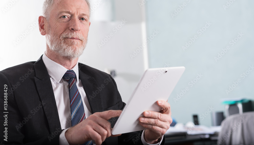 Portrait of senior businessman working on tablet Portrait of senior businessman working on tablet