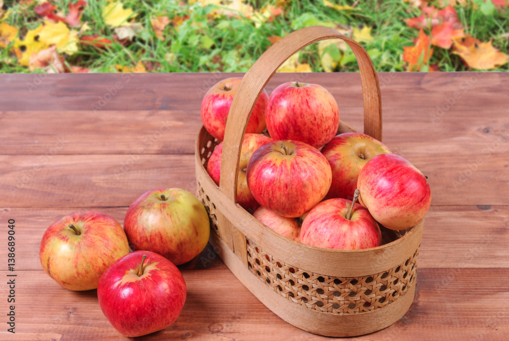 Basket with apples on a wooden background. Basket with apples on a wooden background.