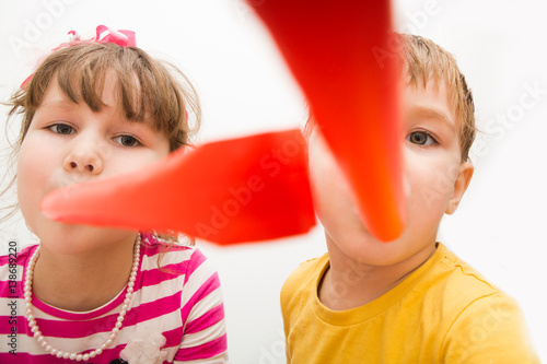Children's funny birthday party. Little boy and the girl have fun on a children's holiday.