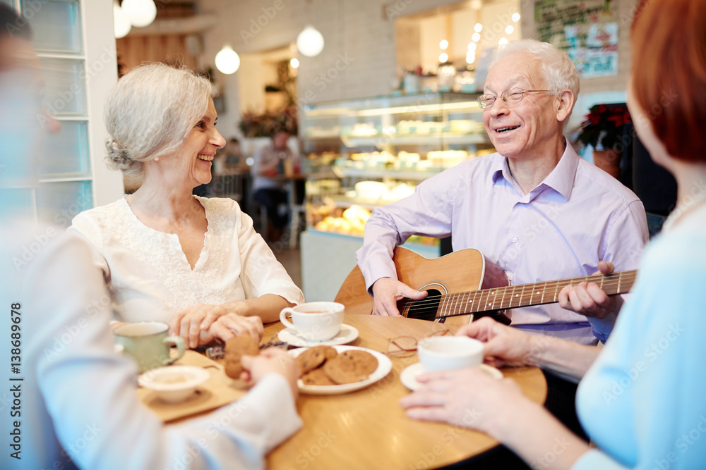 Cheerful senior buddies having merry time in cafe Cheerful senior buddies having merry time in cafe