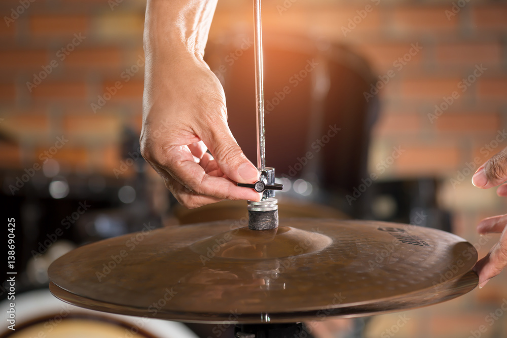 Hands setting hihat of drum kit.Drummer adjusting hihat for a proper sound and feeling in live concert. Hands setting hihat of drum kit.Drummer adjusting hihat for a proper sound and feeling in live concert.