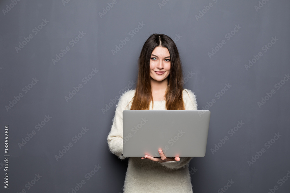 young woman standing and holding laptop. young woman standing and holding laptop.