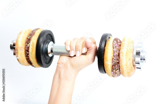 Healthy lifestyle concept suggested by weightlifting doughnuts Fototapeta