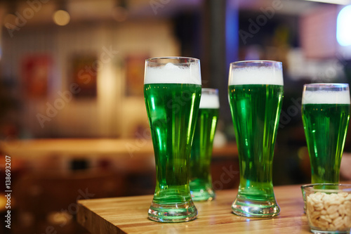 Group of glasses with Irish beer on wooden table