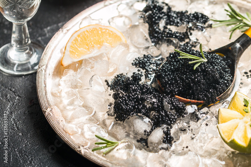 Black caviar in spoon photo