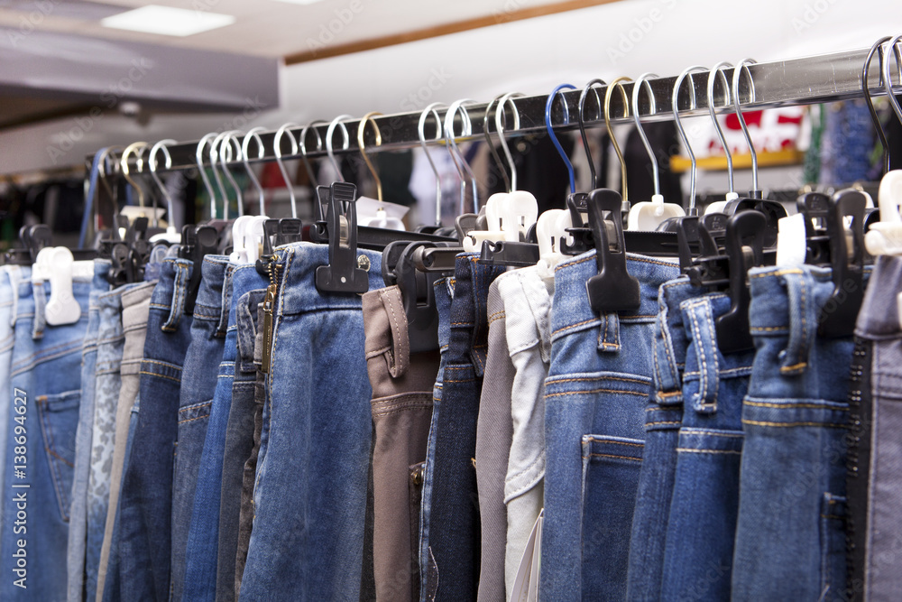 Blue and purple jeans in a shop