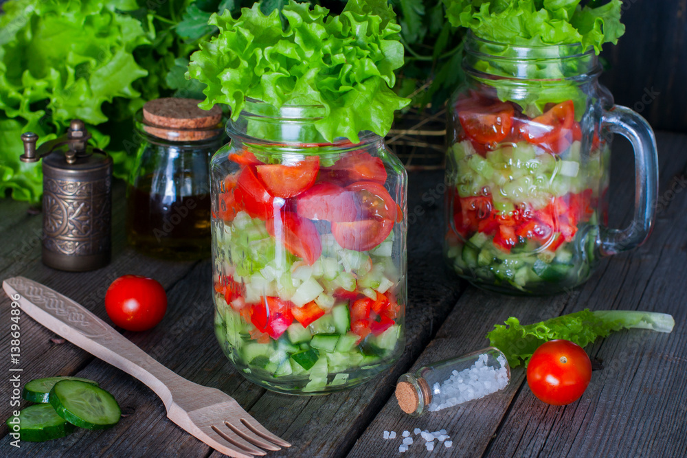 Fresh red and green vegetables in glass jar, selective focus Fresh red and green vegetables in glass jar, selective focus